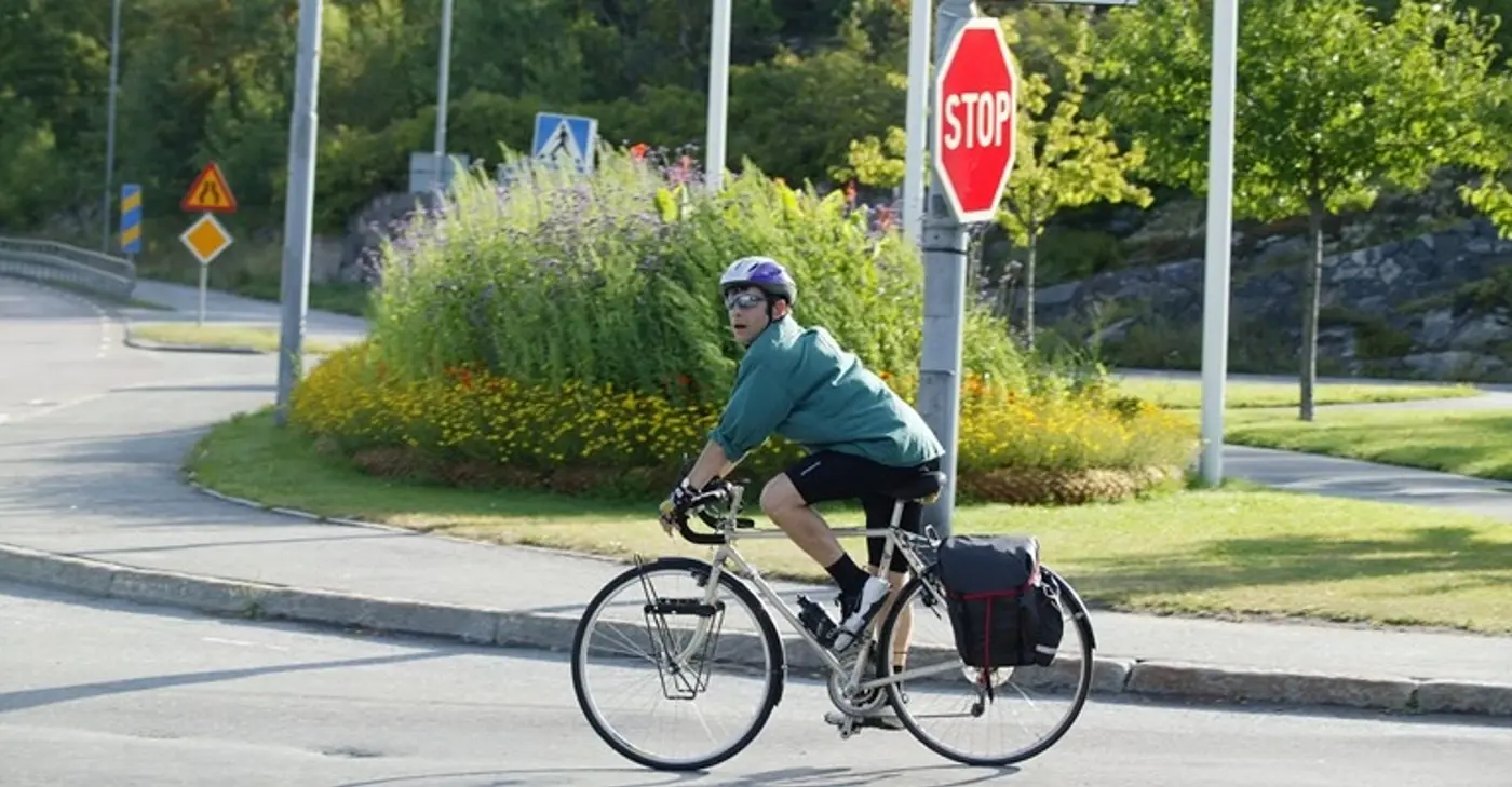 En cyklist cyklar passerar en stoppskylt.
